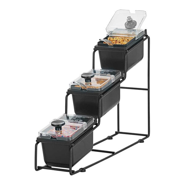 A Server WireWise 3 compartment tiered condiment bar on a counter with three trays of food.