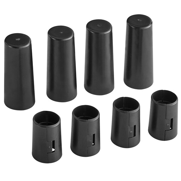 A group of black plastic caps with a hole in the middle.