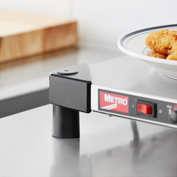 A close-up of Metro countertop converter feet on a table with a bowl of fried chicken.