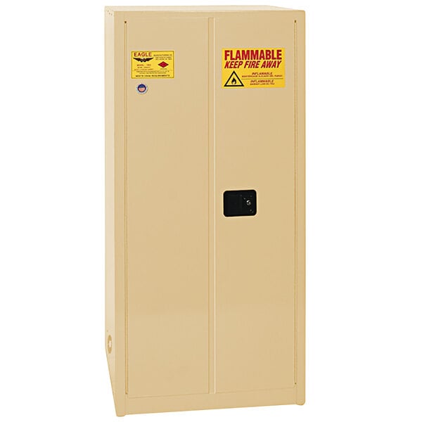 A beige Eagle Manufacturing safety cabinet with white manual-closing doors and yellow warning labels.