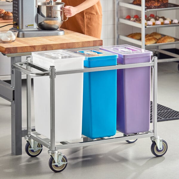 A mobile triple ingredient bin with white, blue, and purple containers on a metal frame with wheels.