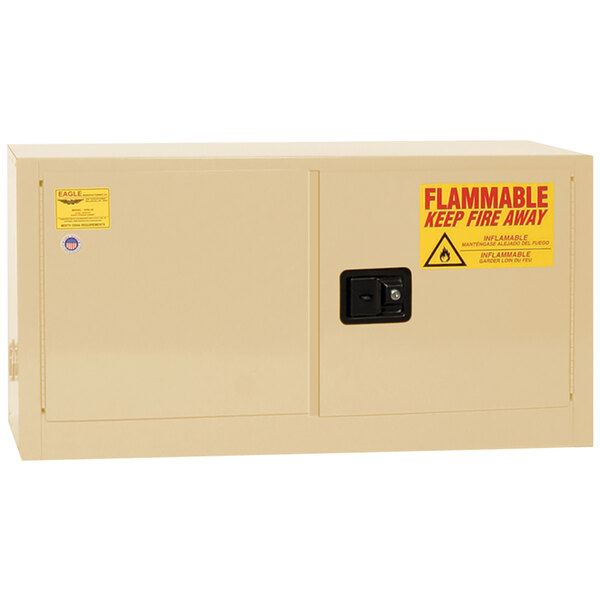 A beige metal safety cabinet with a yellow label.