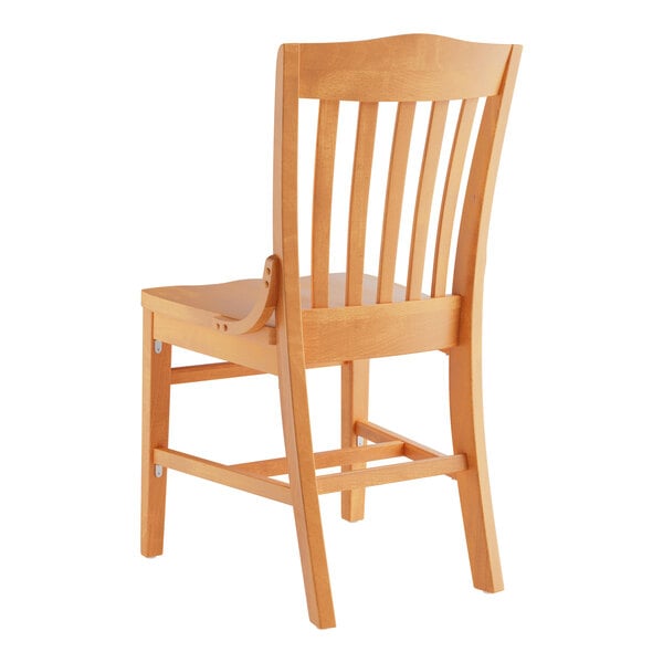 A Lancaster Table & Seating wooden school house chair with a natural finish.