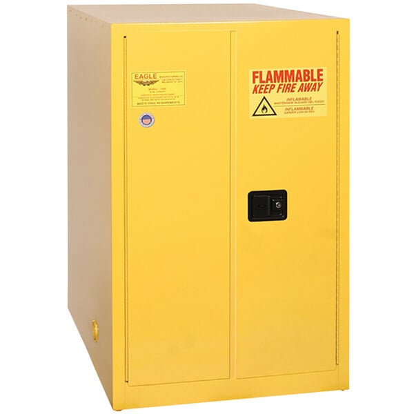 A yellow metal safety cabinet with red and white labels.