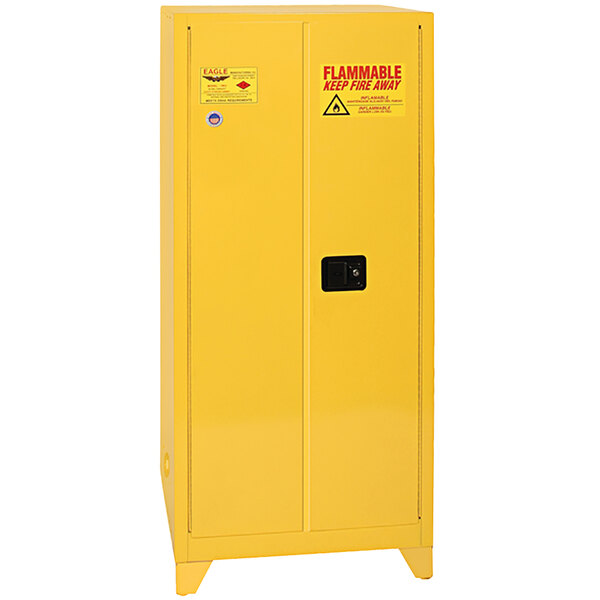 A yellow metal safety cabinet with manual-closing doors.