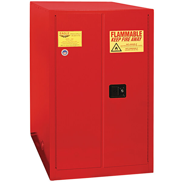 A red Eagle Manufacturing safety cabinet with a yellow and red warning label.