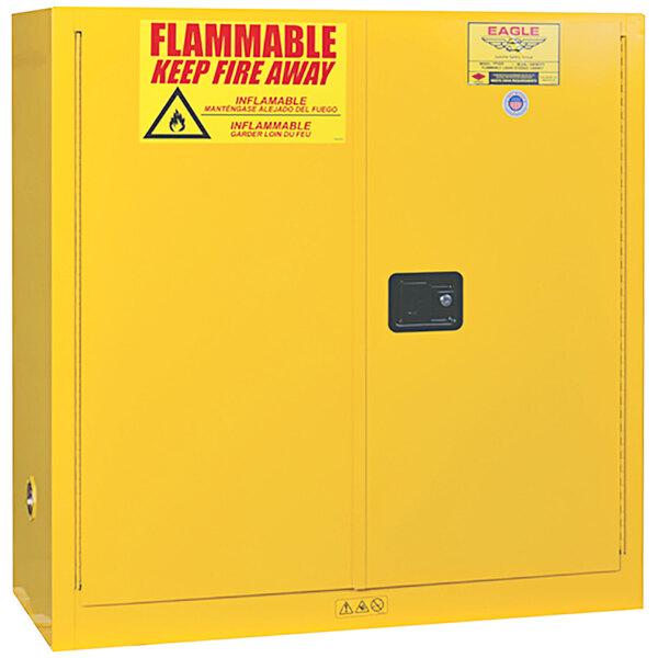 A yellow Eagle safety cabinet with a red "Flammable Keep Away" sign.