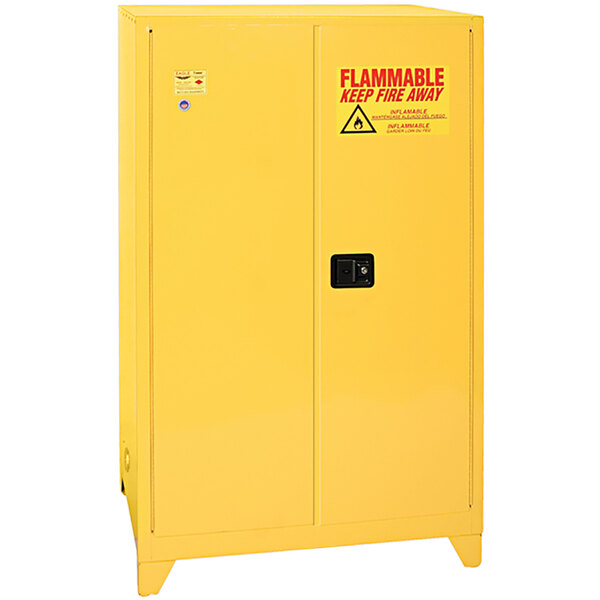 A yellow Eagle Manufacturing safety cabinet with a warning sign.