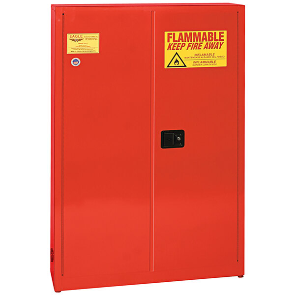 A red metal Eagle safety cabinet with yellow warning labels on the doors.