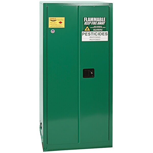 A green metal Eagle Manufacturing safety cabinet with two doors.