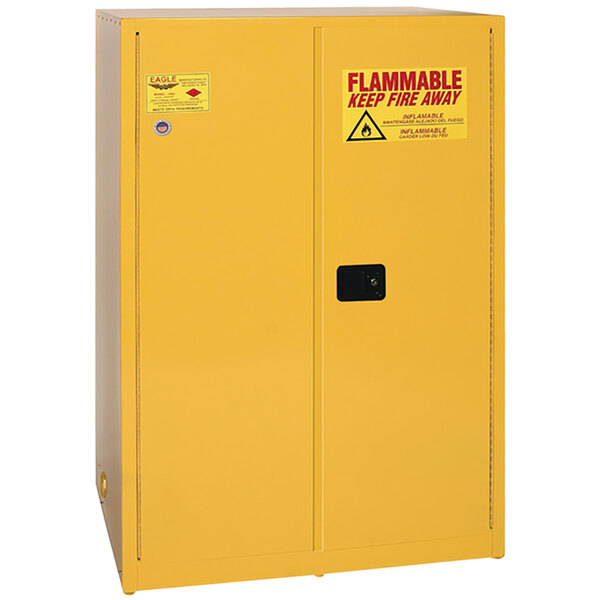 A yellow metal Eagle Manufacturing flammable liquid safety cabinet with a warning sign.