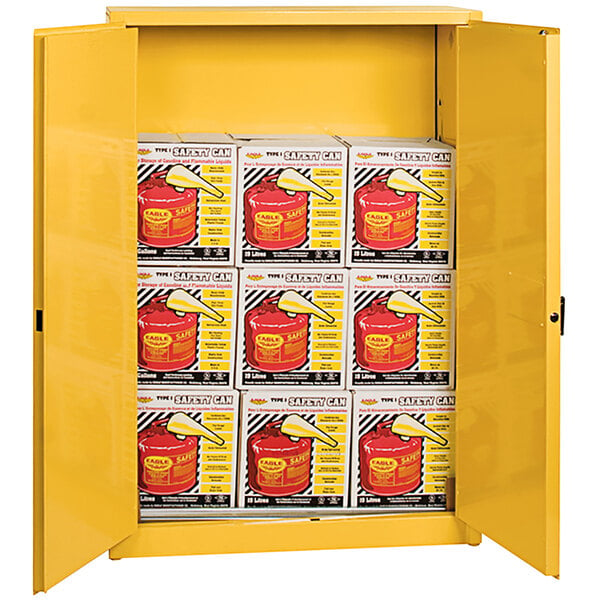 A yellow Eagle Manufacturing safety cabinet with red and yellow safety cans inside.