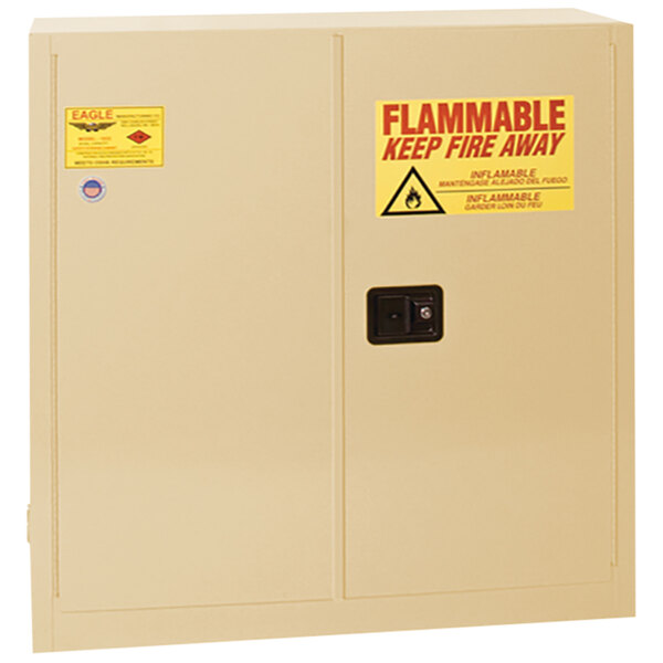 A white Eagle Manufacturing safety cabinet with a yellow and red flammable warning sign.