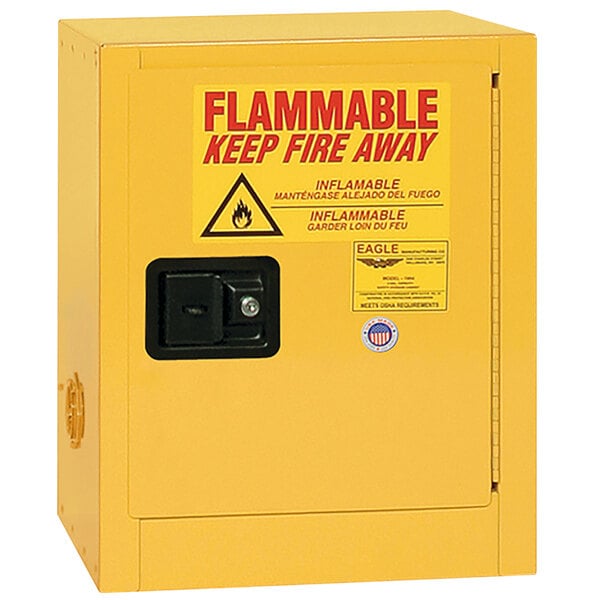 A yellow Eagle Manufacturing flammable liquid safety cabinet with a red and black sign.