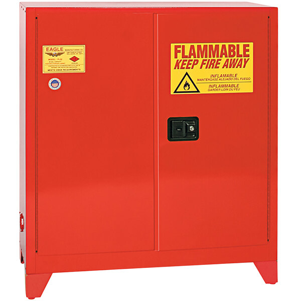 A red Eagle safety cabinet with a yellow and red sign reading "flammable keep away"