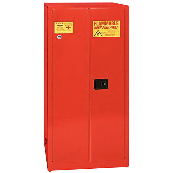 A red metal Eagle Safety Cabinet with a yellow and red sign.