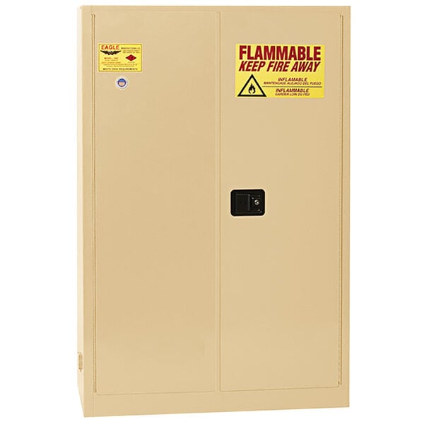 A tan Eagle Manufacturing flammable safety cabinet with yellow labels.