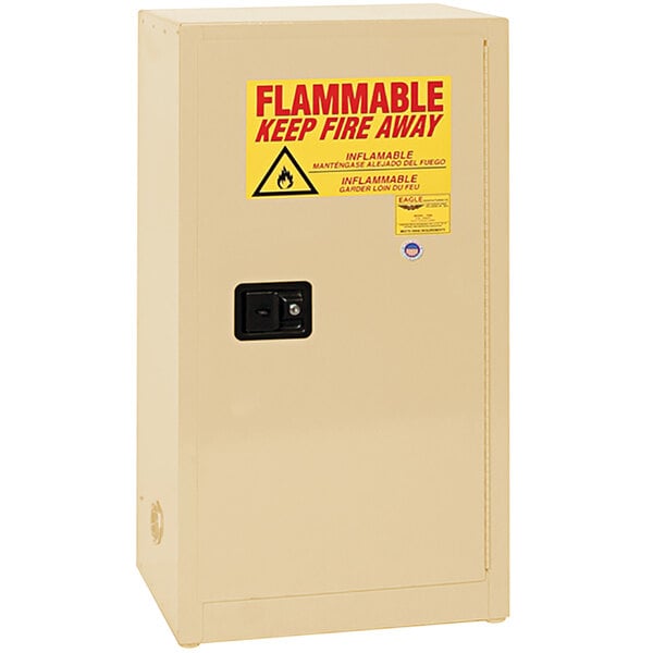 A beige Eagle safety cabinet with a yellow flammable liquid sign.