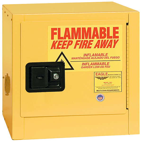 A yellow metal Eagle Manufacturing safety cabinet with a black manual-closing door.