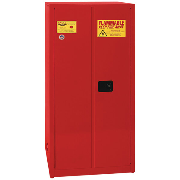 A red metal Eagle safety cabinet with yellow labels on the doors.