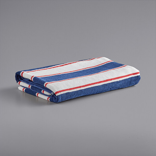 A folded Monarch Brands pool towel with navy and red stripes on a gray surface.