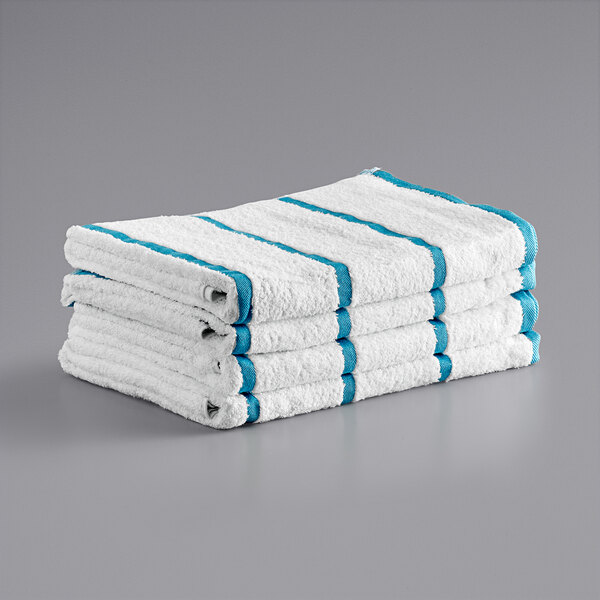 A stack of white towels with blue stripes.