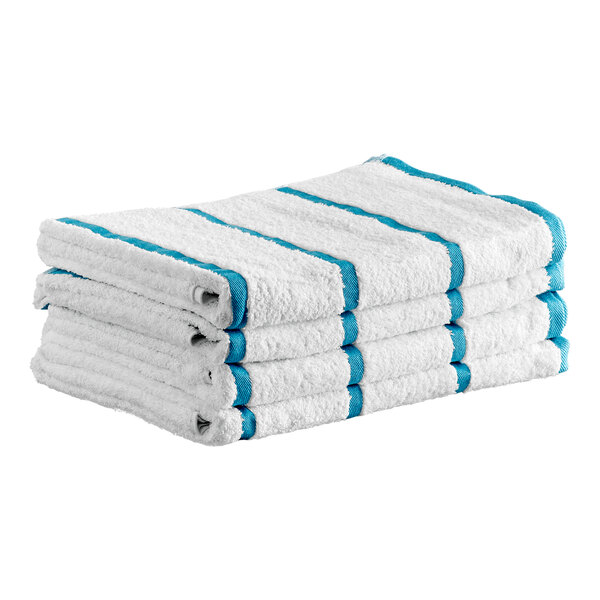 A stack of four white towels with blue stripes, neatly folded.