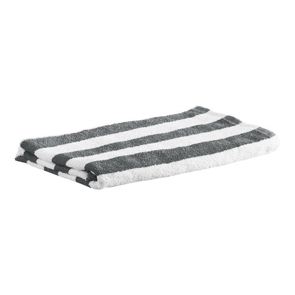 A folded towel with alternating gray and white horizontal stripes.