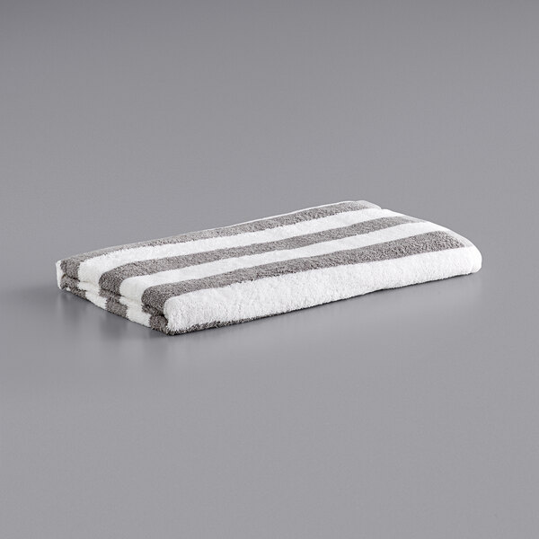 A white and grey striped Monarch Brands pool towel.