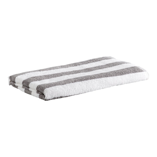 A folded towel with alternating gray and white horizontal stripes.