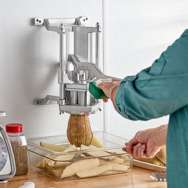 A person using the Garde Heavy-Duty Potato Wedger to cut a potato.