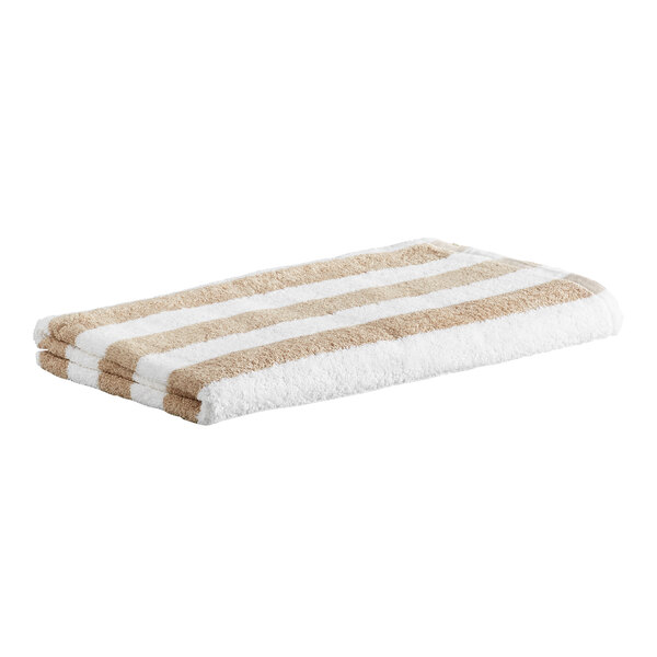 A folded towel with beige and white horizontal stripes.