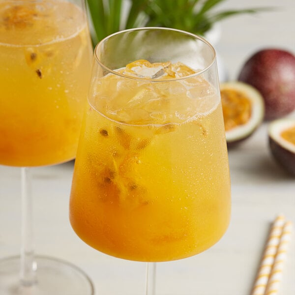 A pair of glasses with a drink made from Les Vergers Boiron passion fruit puree.