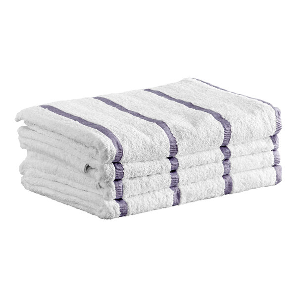 A stack of white towels with light gray stripes folded neatly.