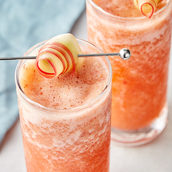 Two glasses of pink liquid made with Les Vergers Boiron Rhubarb Fruit Puree with straws.