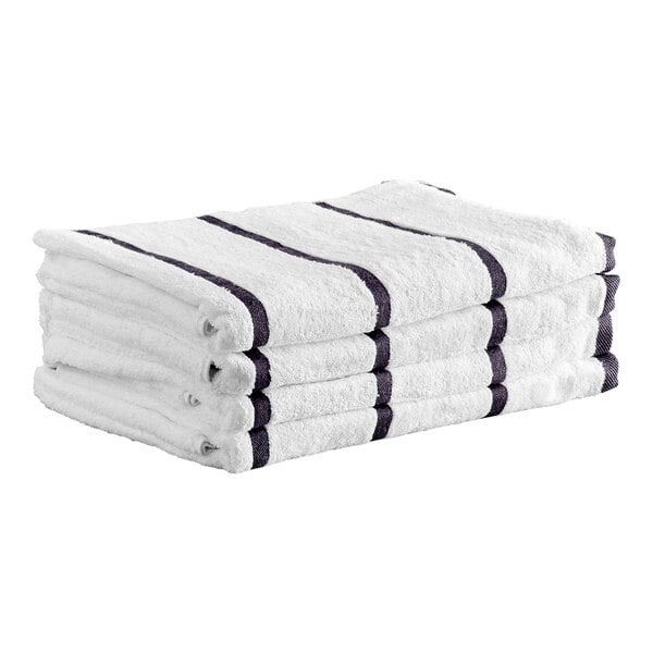 A stack of four white towels with dark gray stripes, neatly folded.