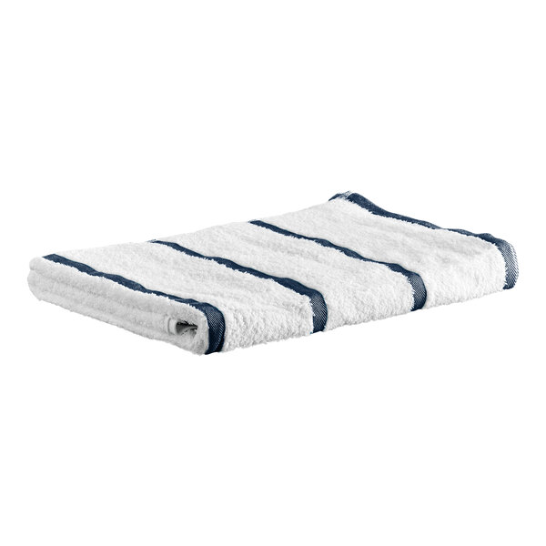 A folded white towel with evenly spaced navy blue stripes.