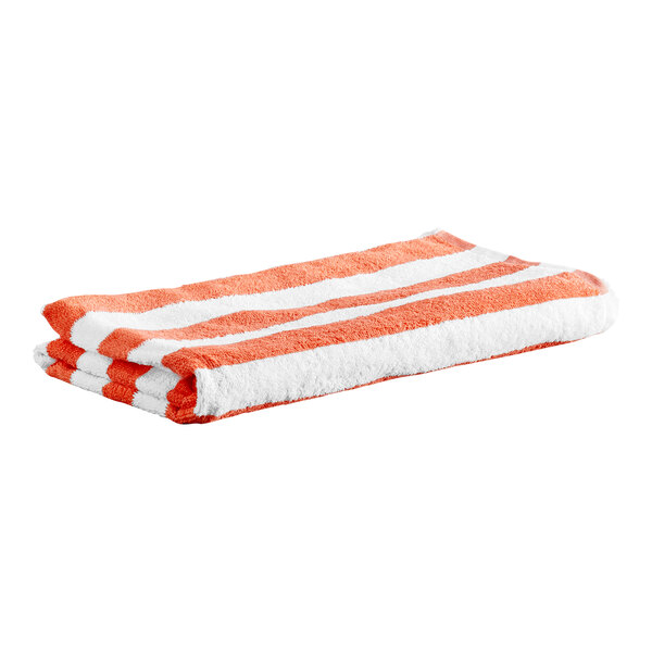 A folded towel with coral red and white stripes.