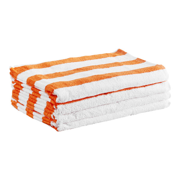 A stack of four folded towels with orange and white horizontal stripes.