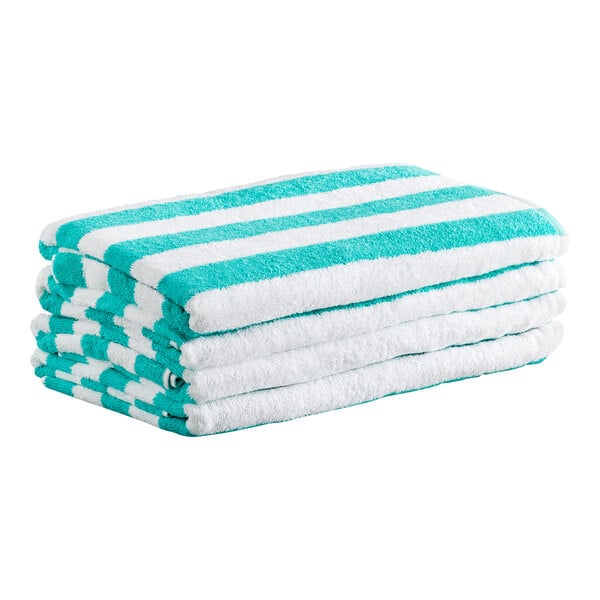A stack of four folded towels with green and white horizontal stripes.