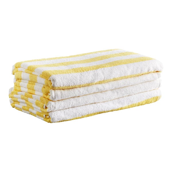 A stack of four folded towels with yellow and white stripes.