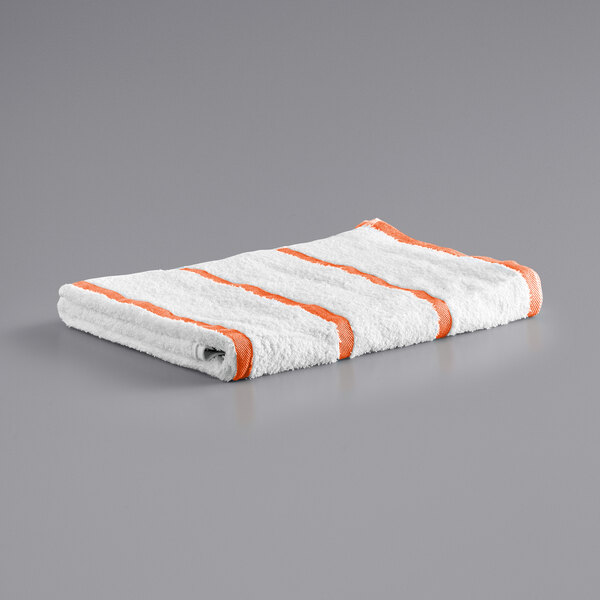 A white and orange Monarch Brands pool towel with stripes.