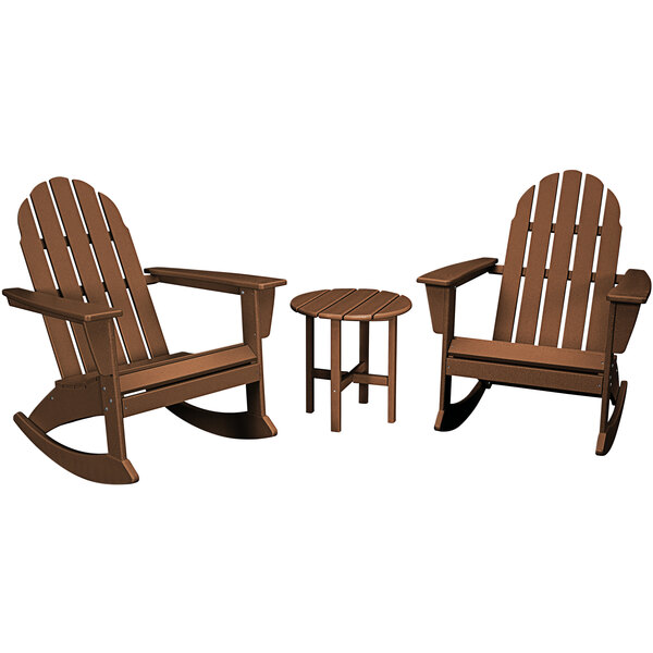 A round wooden table with a group of brown wooden rocking chairs with armrests.