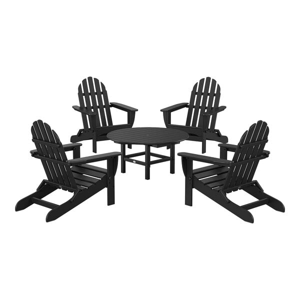 A black POLYWOOD table with four black POLYWOOD Adirondack chairs around it.