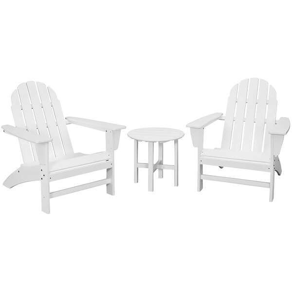 A group of white POLYWOOD Adirondack chairs and a table.