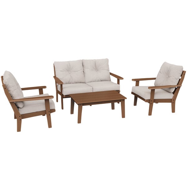 A white POLYWOOD deep seating chair with a cushion next to a brown wood table.