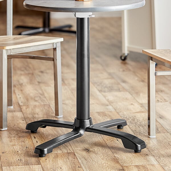 A black FLAT Tech table base with a wooden top flipped up.