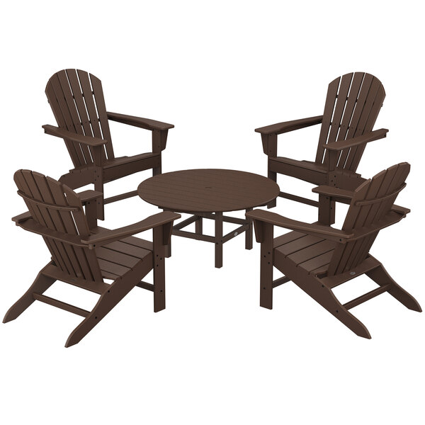 A round brown POLYWOOD patio table with four Adirondack chairs around it.