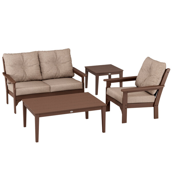A POLYWOOD Vineyard deep seating set with chairs and small tables on a patio.