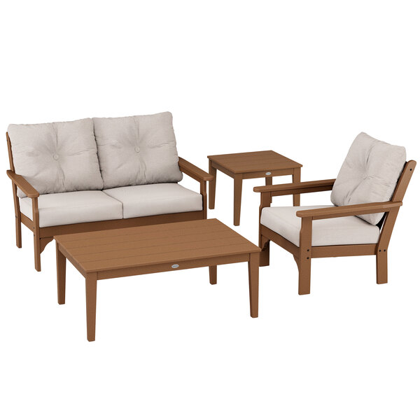 A POLYWOOD teak and burlap patio set with chairs and small tables.